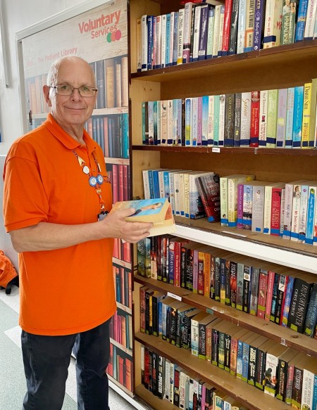 Volunteer Richard with the donated books library.jpg