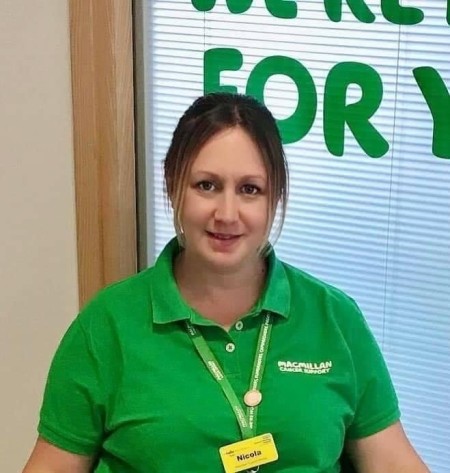 Woman with dark hair wearing a green polo short