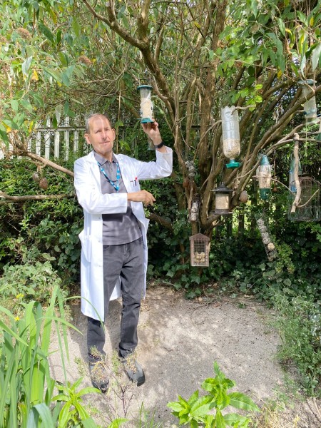 Mark with the bird feeders in the nature area